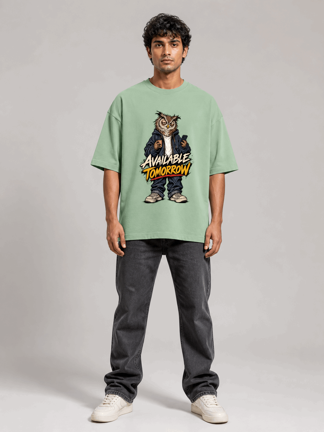 Available Tomorrow Owl jade oversized T-shirt on Indian male model, full-length studio view