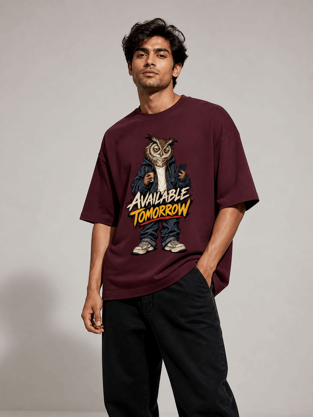 Available Tomorrow Owl maroon oversized T-shirt on Indian male model, three-quarter studio view