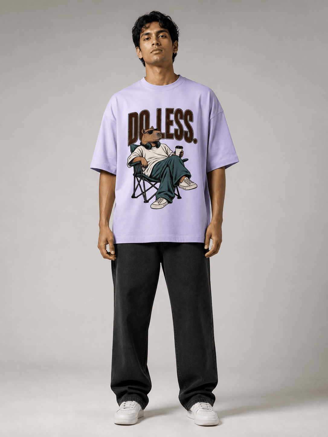 Do Less Capybara lavender oversized T-shirt on Indian male model, full-length studio view