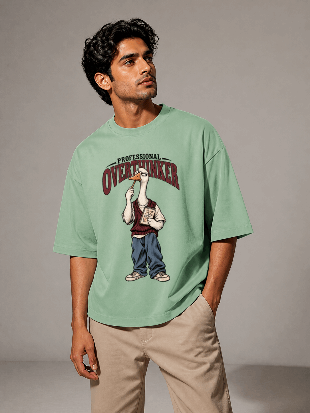 Professional Overthinker Goose jade oversized T-shirt on Indian male model, three-quarter studio view