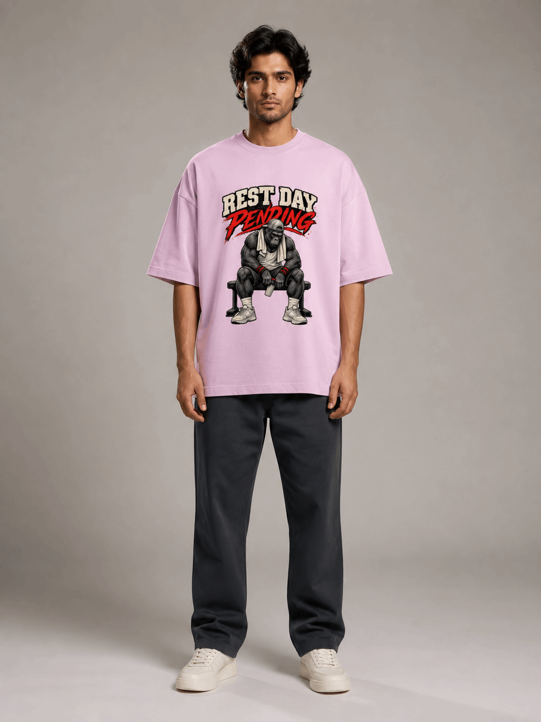 Rest Day Pending Gorilla light baby pink oversized T-shirt on Indian male model, full-length studio view