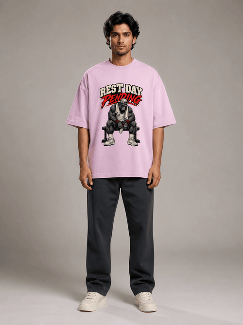 Rest Day Pending Gorilla light baby pink oversized T-shirt on Indian male model, full-length studio view