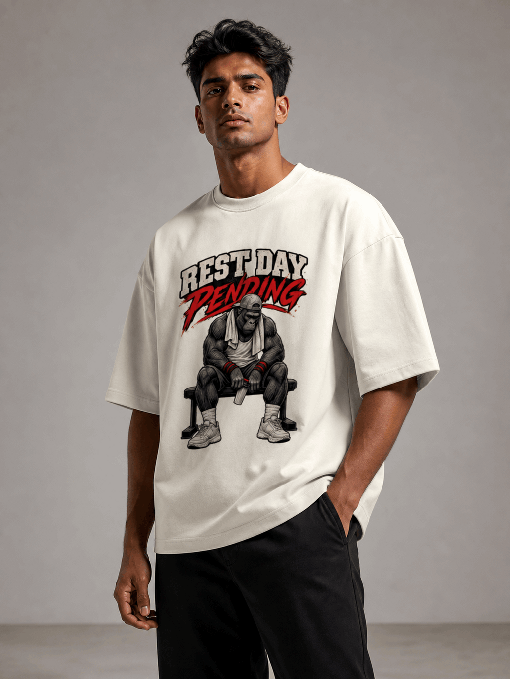 Rest Day Pending Gorilla off white oversized T-shirt on Indian male model, three-quarter studio view