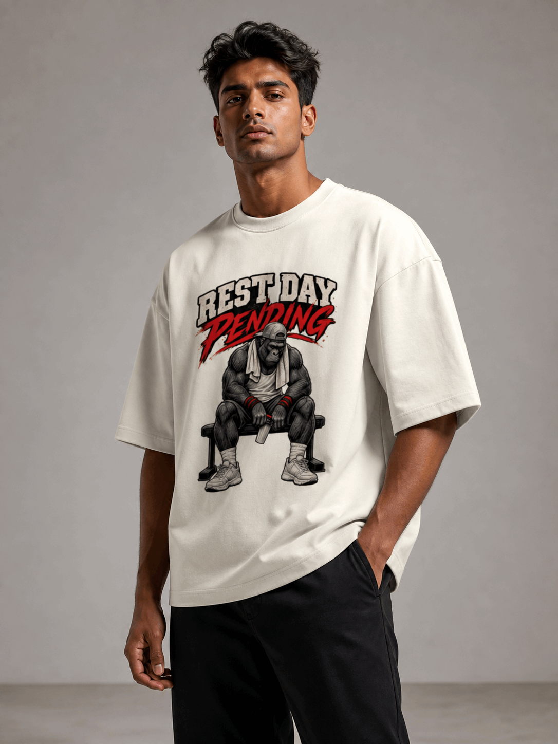 Rest Day Pending Gorilla off white oversized T-shirt on Indian male model, three-quarter studio view