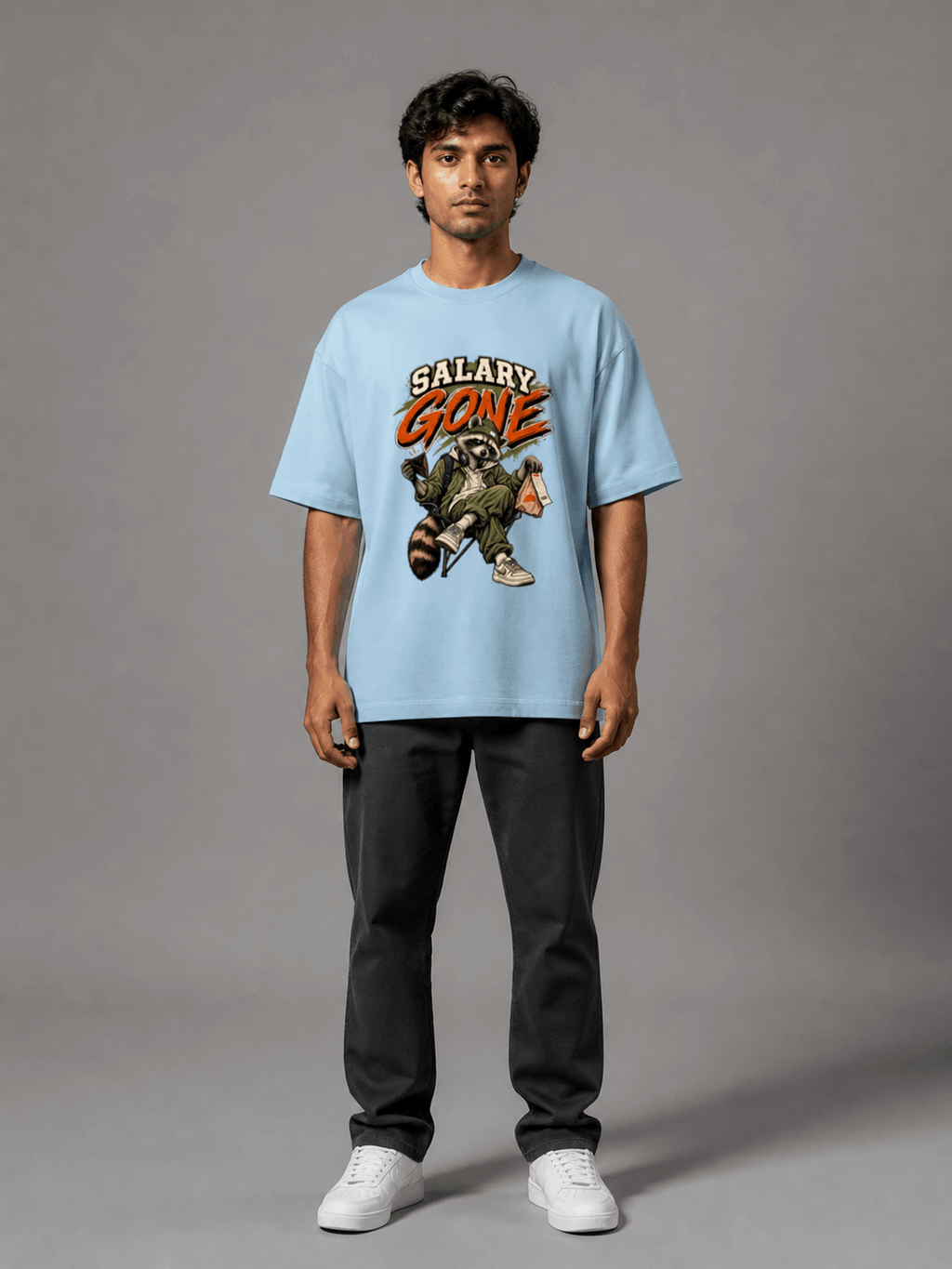 Salary Gone Raccoon baby blue oversized T-shirt on Indian male model, full-length studio view