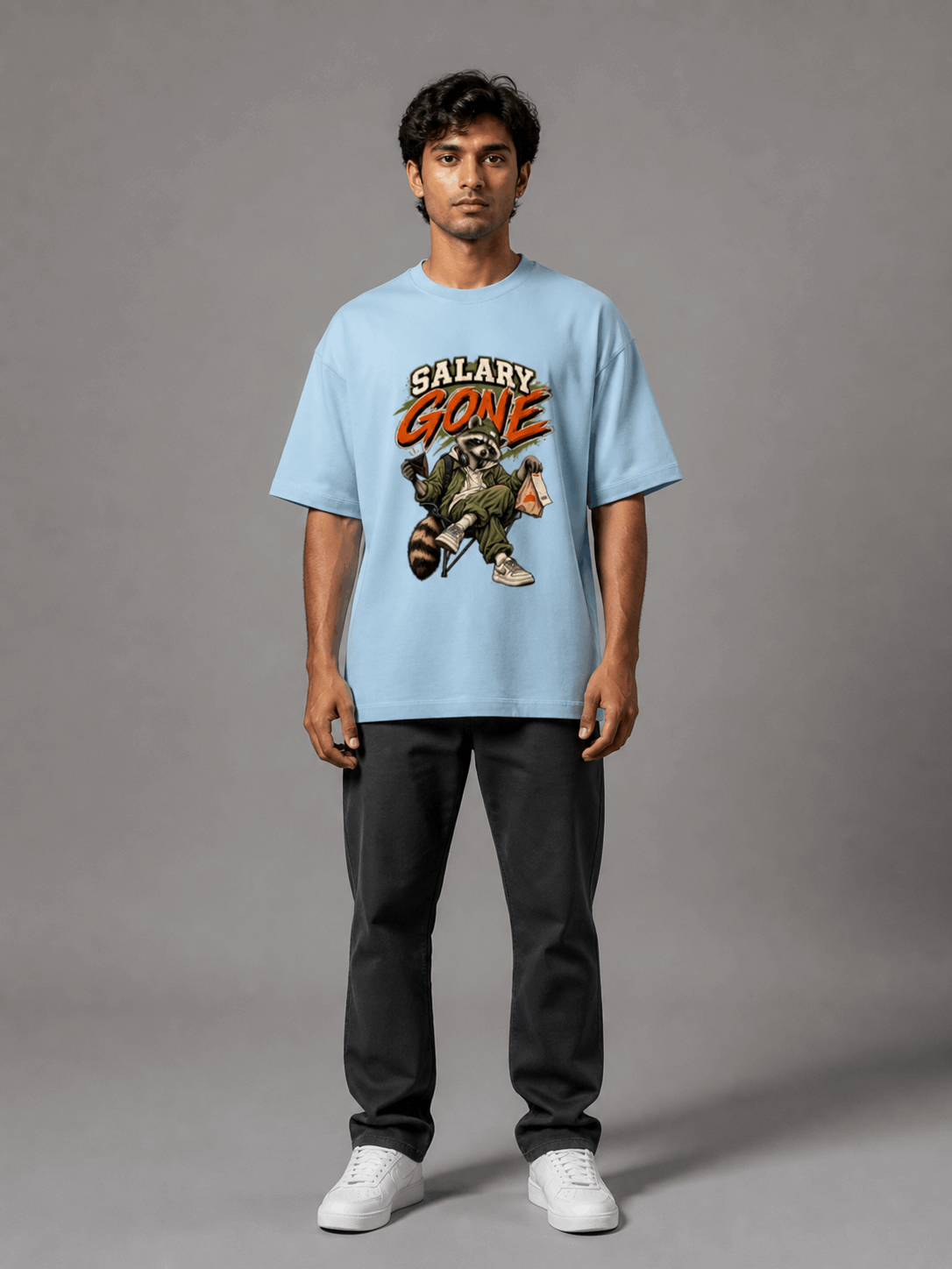 Salary Gone Raccoon baby blue oversized T-shirt on Indian male model, full-length studio view