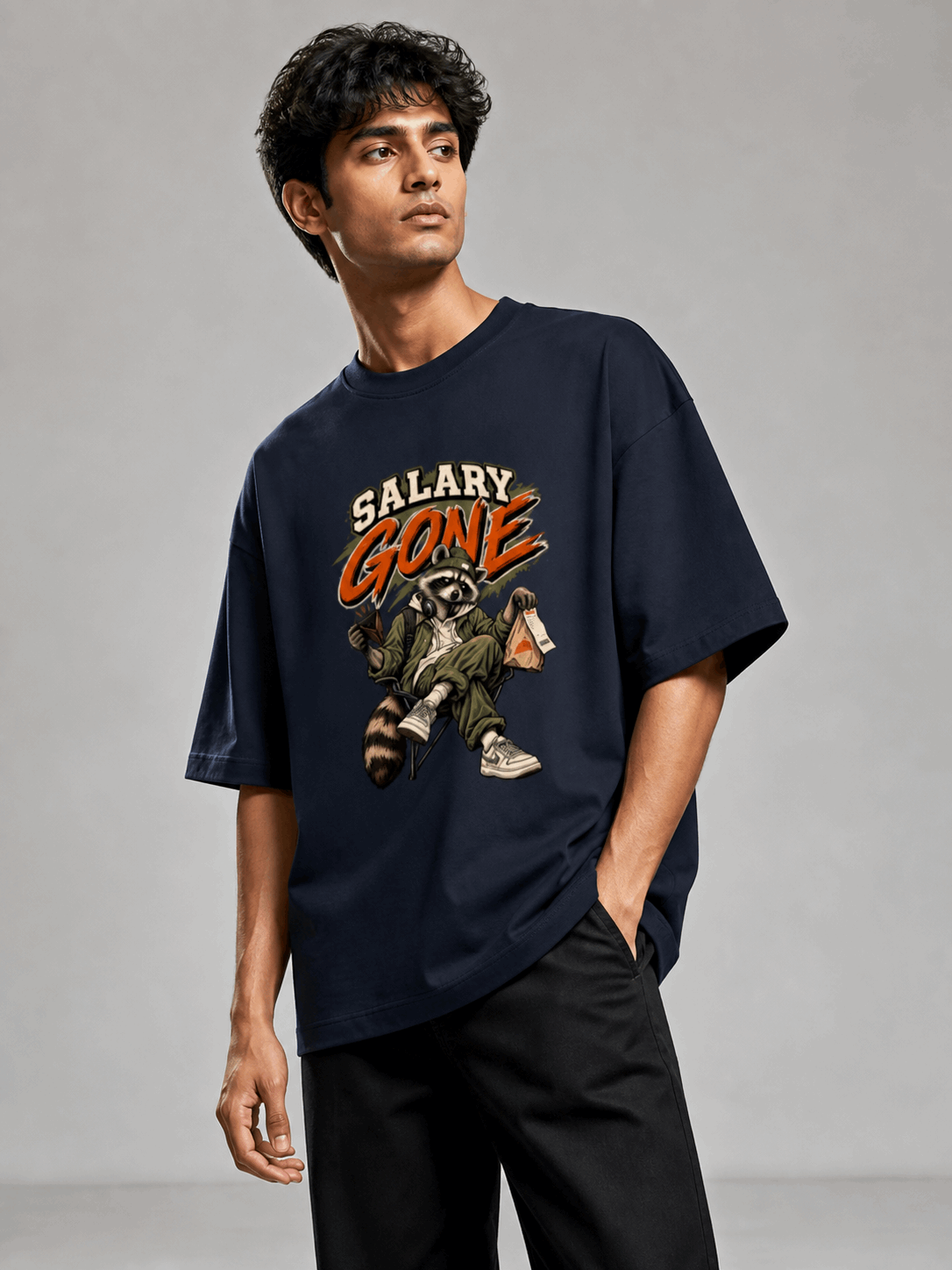 Salary Gone Raccoon navy blue oversized T-shirt on Indian male model, three-quarter studio view