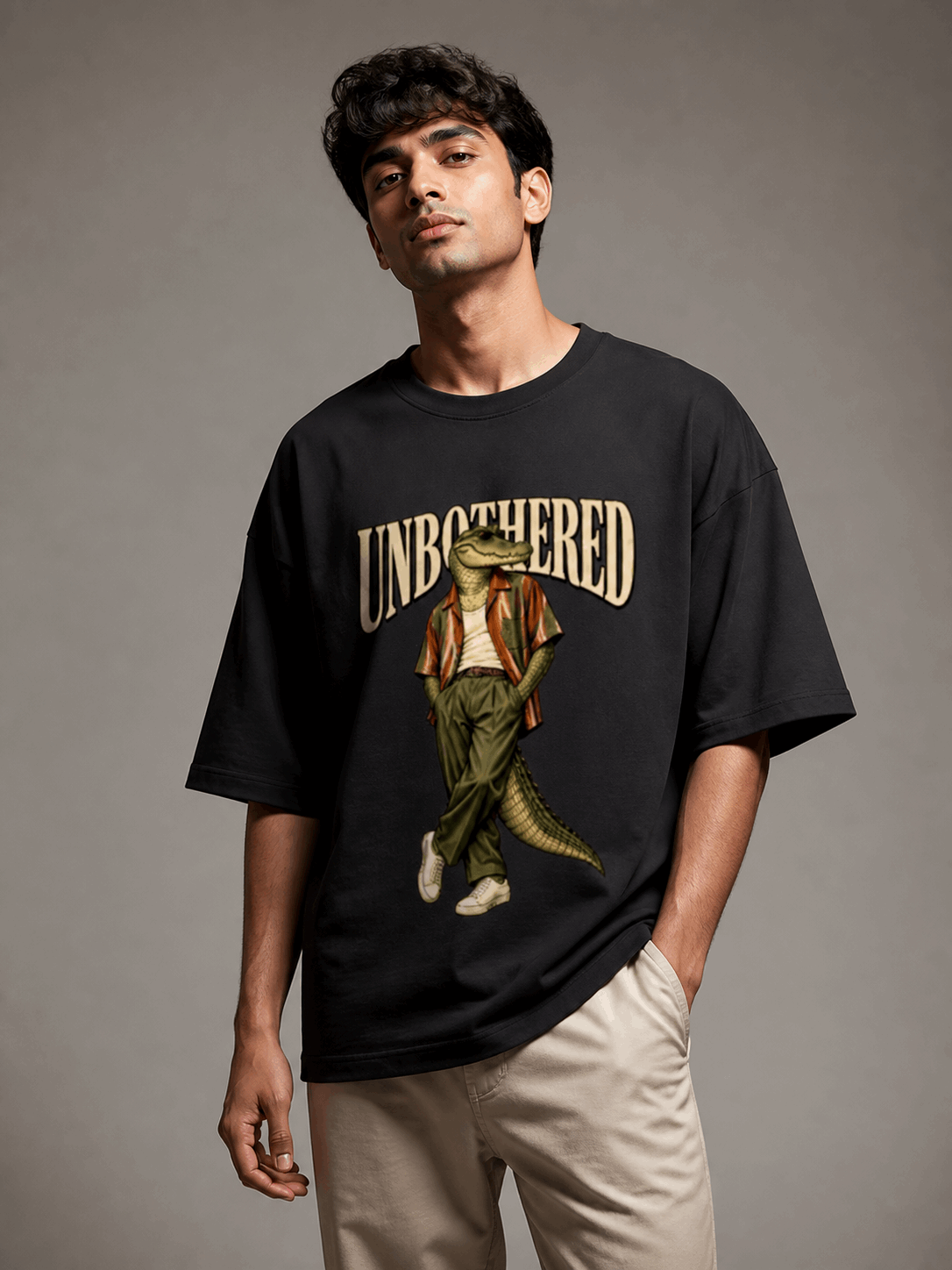 Unbothered Crocodile black oversized T-shirt on Indian male model, three-quarter studio view