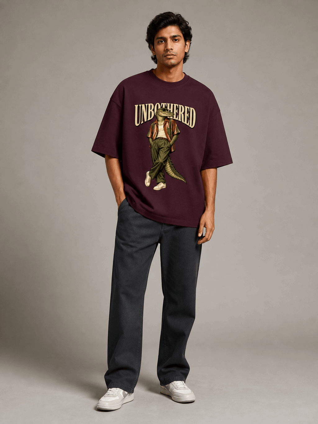 Unbothered Crocodile maroon oversized T-shirt on Indian male model, full-length studio view