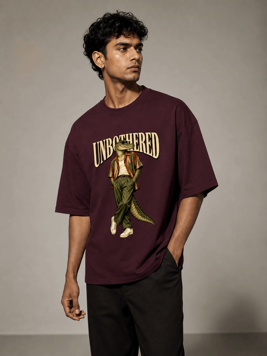 Unbothered Crocodile maroon oversized T-shirt on Indian male model, three-quarter studio view