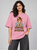 Coffee Has My Attention Cat Flamingo oversized T-shirt on an Indian female model, front studio view