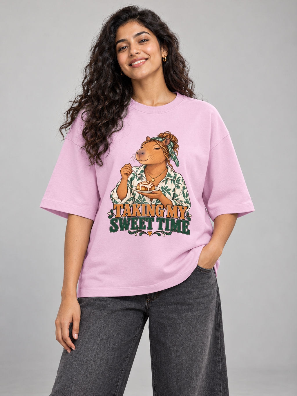 Taking My Sweet Time Capybara Light Baby Pink oversized T-shirt on an Indian female model, front studio view
