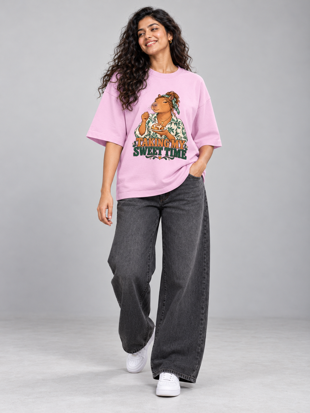 Taking My Sweet Time Capybara Light Baby Pink oversized T-shirt on an Indian female model, full-length studio view