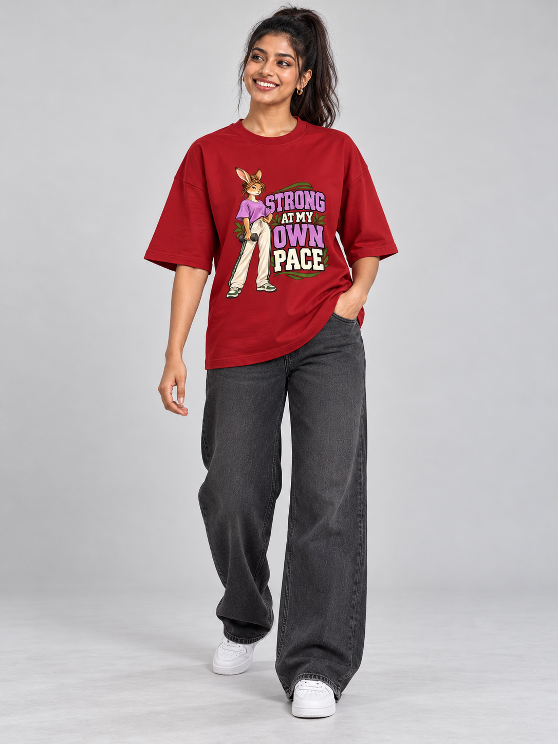 Strong at My Own Pace Hare Red oversized T-shirt on an Indian female model, full-length studio view